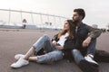 pensive couple in casual clothing looking away while resting