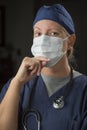 Pensive Doctor or Nurse Wearing Protective Face Mask Royalty Free Stock Photo