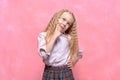 Pensive dreaming little girl schoolgirl. pink background