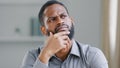 Pensive ethnic bearded African American man thinking businessman searching solution of difficult problem boss think Royalty Free Stock Photo