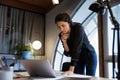 Pensive ethnic businesswoman look at laptop screen analyzing document