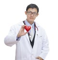 Pensive experienced profaser asian doctor while looking and smile hand holding  red heart. General practitioner concept isolated Royalty Free Stock Photo