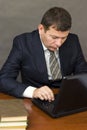 Pensive face businessman sitting at computer