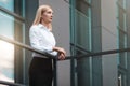 Pensive female boss walked out onto the roof of an office building. Beautiful woman middle-aged office worker Royalty Free Stock Photo