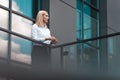 Pensive female boss walked out onto the roof of an office building. Beautiful woman middle-aged office worker Royalty Free Stock Photo