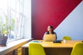 Pensive female freelance social media content writer thinking and looking in window