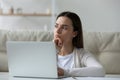 Pensive girl sit in front of laptop thinking over task Royalty Free Stock Photo