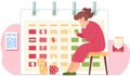 Pensive girl sits with cards in her hands. Cubes on the floor. Timetable or a calendar on background