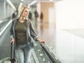 Pensive girl standing on escalator