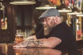 Pensive guy drinking light ale in pub