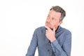 Pensive handsome man in casual blue shirt hand fingers on chin posing isolated on white background studio portrait Royalty Free Stock Photo