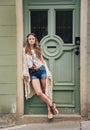 Pensive hippie woman in boho clothes standing outdoors