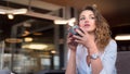 Pensive lady with cup of tea has a rest at the cafe Royalty Free Stock Photo