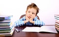 Pensive little boy sitting at a desk Royalty Free Stock Photo