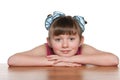 Pensive little girl at the desk Royalty Free Stock Photo