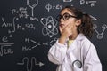 Pensive little girl science student in lab coat