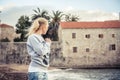 Pensive lonely woman standing on beach and looking into the distance wind blowing woman hairs