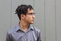 Pensive looking young African American man in profile looking up, eyeglasses and collared shirt Royalty Free Stock Photo