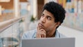 Pensive male african american guy rubbing chin thinking solution problem plan strategy startup idea sitting with laptop Royalty Free Stock Photo