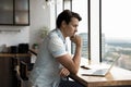 Pensive male employee work on laptop thinking Royalty Free Stock Photo