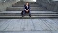 Pensive male sitting on stairs lost money on stock market, bankruptcy, dismissal