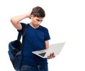 Pensive male student holding laptop