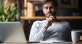 Pensive male thinking over problem solution working on laptop Royalty Free Stock Photo