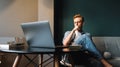 Pensive man college student in glasses studying with books laptop distantly Royalty Free Stock Photo