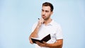 pensive man holding pen and notebook Royalty Free Stock Photo