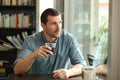 Pensive man looking throw window in a coffee shop Royalty Free Stock Photo