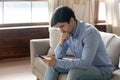 Pensive man read message on cellphone thinking Royalty Free Stock Photo