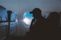 A pensive man sits at the window on an airplane Royalty Free Stock Photo