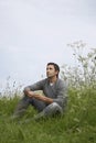 Pensive man sitting in field Royalty Free Stock Photo