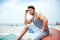 Pensive man sitting on a fishing boat by the sea Royalty Free Stock Photo