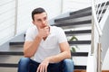 Pensive man sitting on the stairs Royalty Free Stock Photo