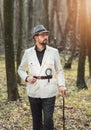 Pensive man standing among trees