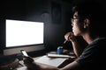 Pensive man studying with blank screen computer and smartphone Royalty Free Stock Photo