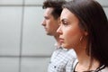 Pensive man and woman stand near wall Royalty Free Stock Photo