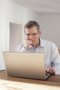 Pensive man working with laptop Royalty Free Stock Photo