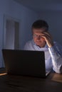 Pensive man working with laptop by at night Royalty Free Stock Photo