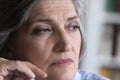 Pensive mature grey haired lady looking away in deep thought Royalty Free Stock Photo