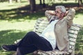 Pensive mature man sitting on bench in an urban park. Royalty Free Stock Photo