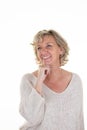 pensive middle aged beautiful senior woman blonde smiling hand over chin posing looking side Royalty Free Stock Photo