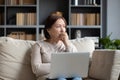 Pensive middle-aged woman look in distance pondering Royalty Free Stock Photo