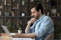 Pensive Caucasian man work on computer thinking Royalty Free Stock Photo