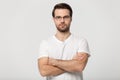 Serious millennial man in glasses posing with arms crossed Royalty Free Stock Photo