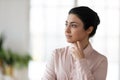 Pensive young Indian woman look in distance thinking Royalty Free Stock Photo