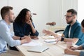 Pensive mixed race teammates discussing project details. Royalty Free Stock Photo