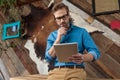 Pensive model holding reading from tablet with hand on chin Royalty Free Stock Photo