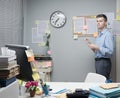 Pensive office worker holding paperwork